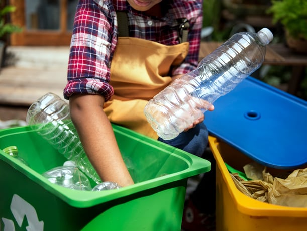 Interwaste - image of a young person sorting plastic waste for recycling